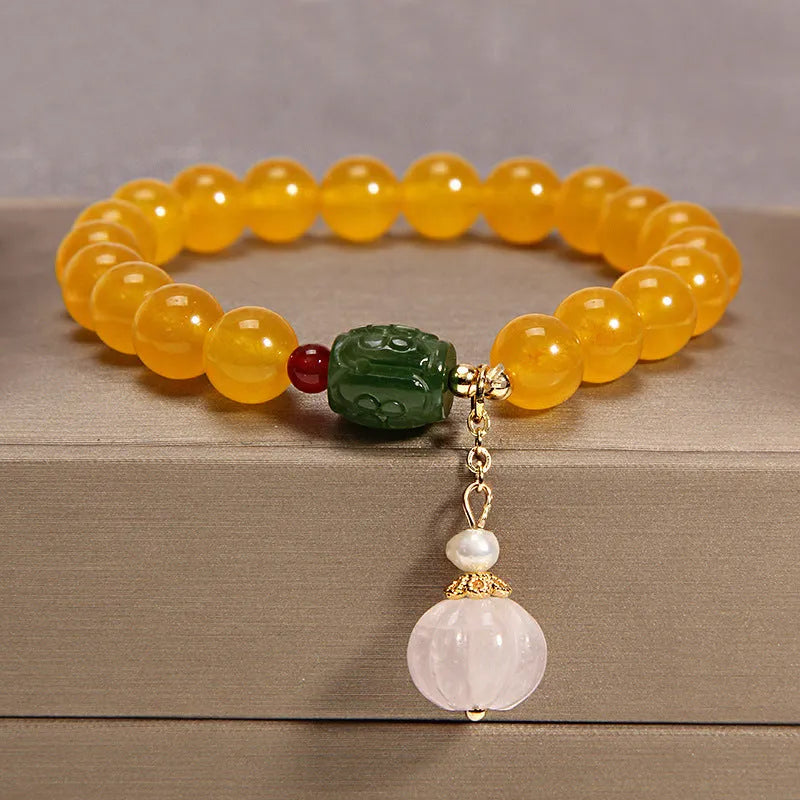 Yellow agate crystal bead bracelet with khaki silk cord and gold tone sliding closure.