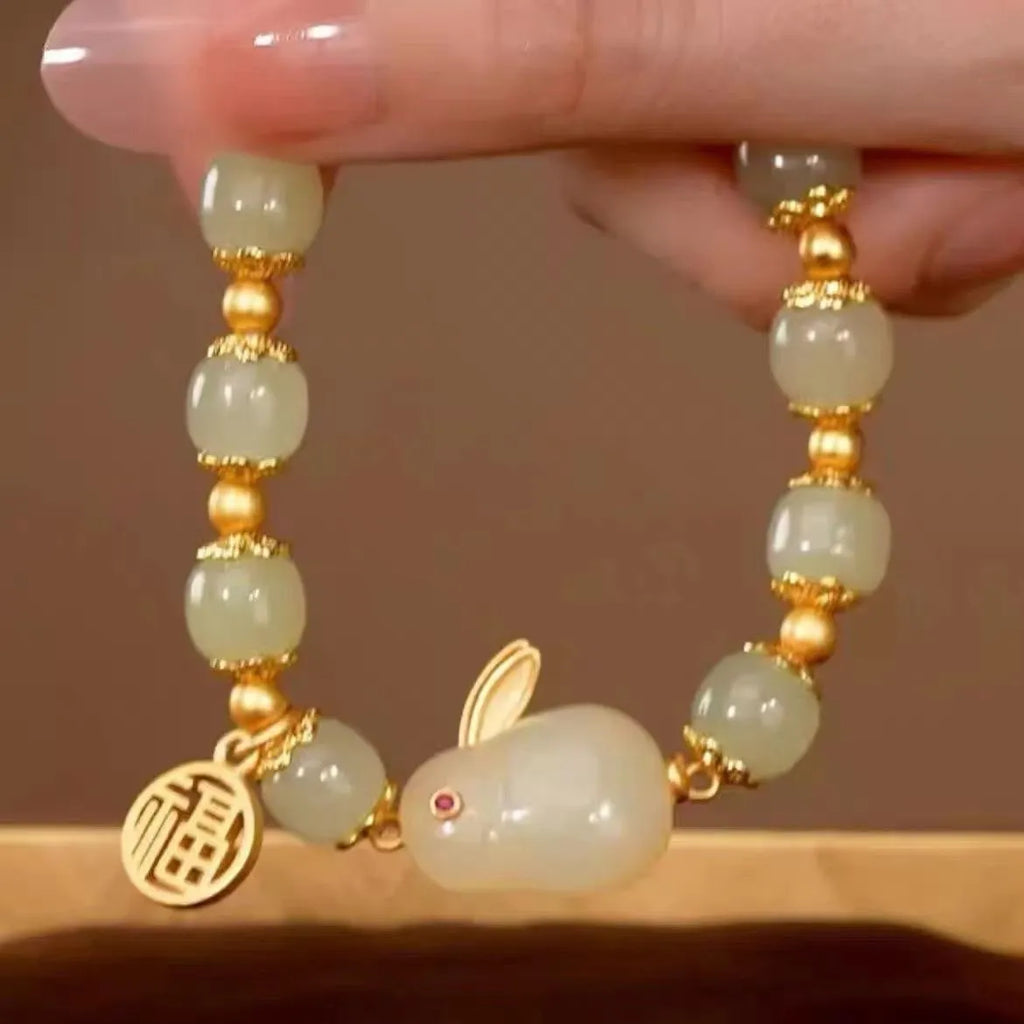 Women's black adjustable bracelet with green jade fu character, jade hare charm, and Lily decorations.