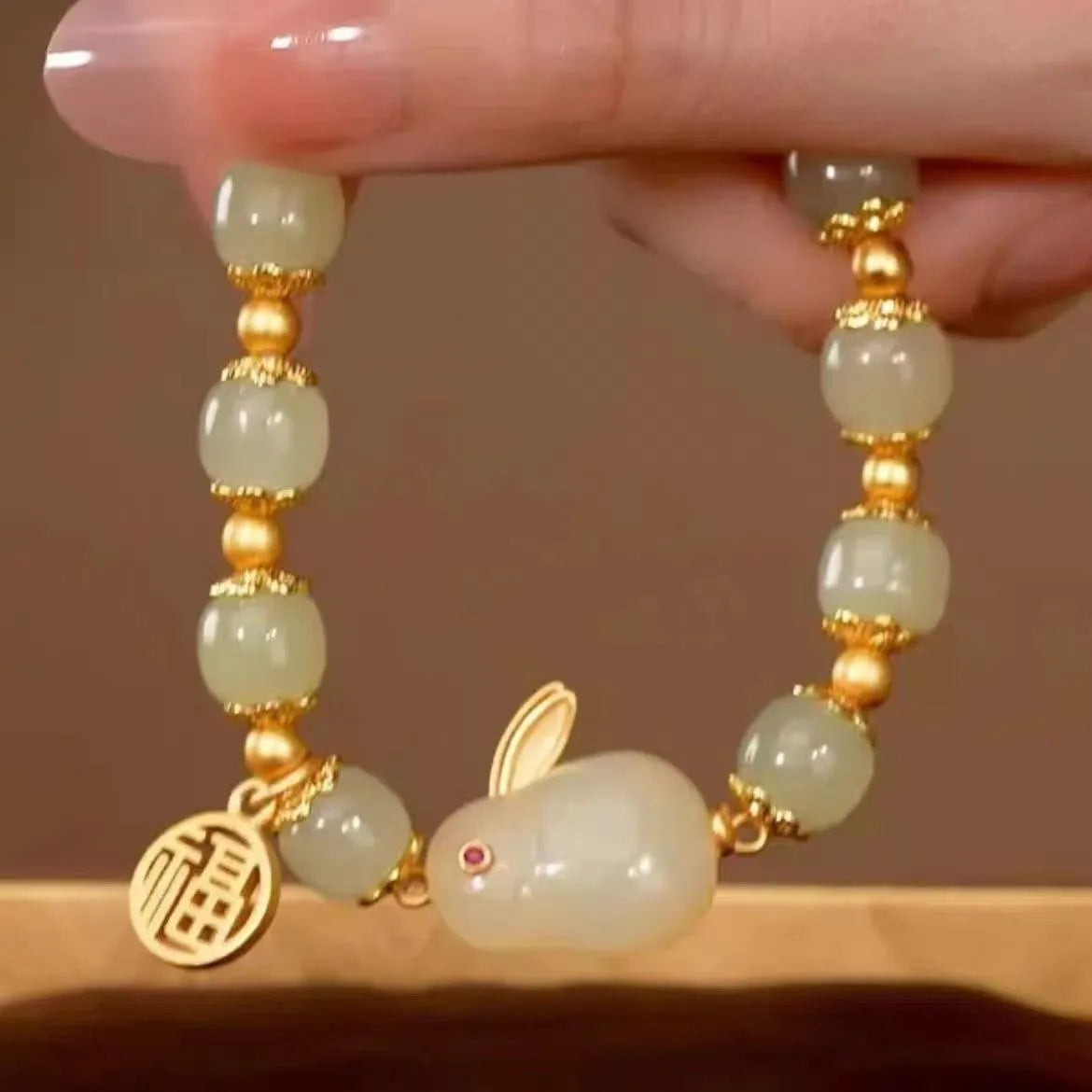 Women's black adjustable bracelet with green jade fu character, jade hare charm, and Lily decorations.