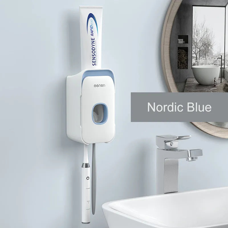 A blue automatic toothpaste dispenser mounted on a bathroom wall with a soft-touch button.