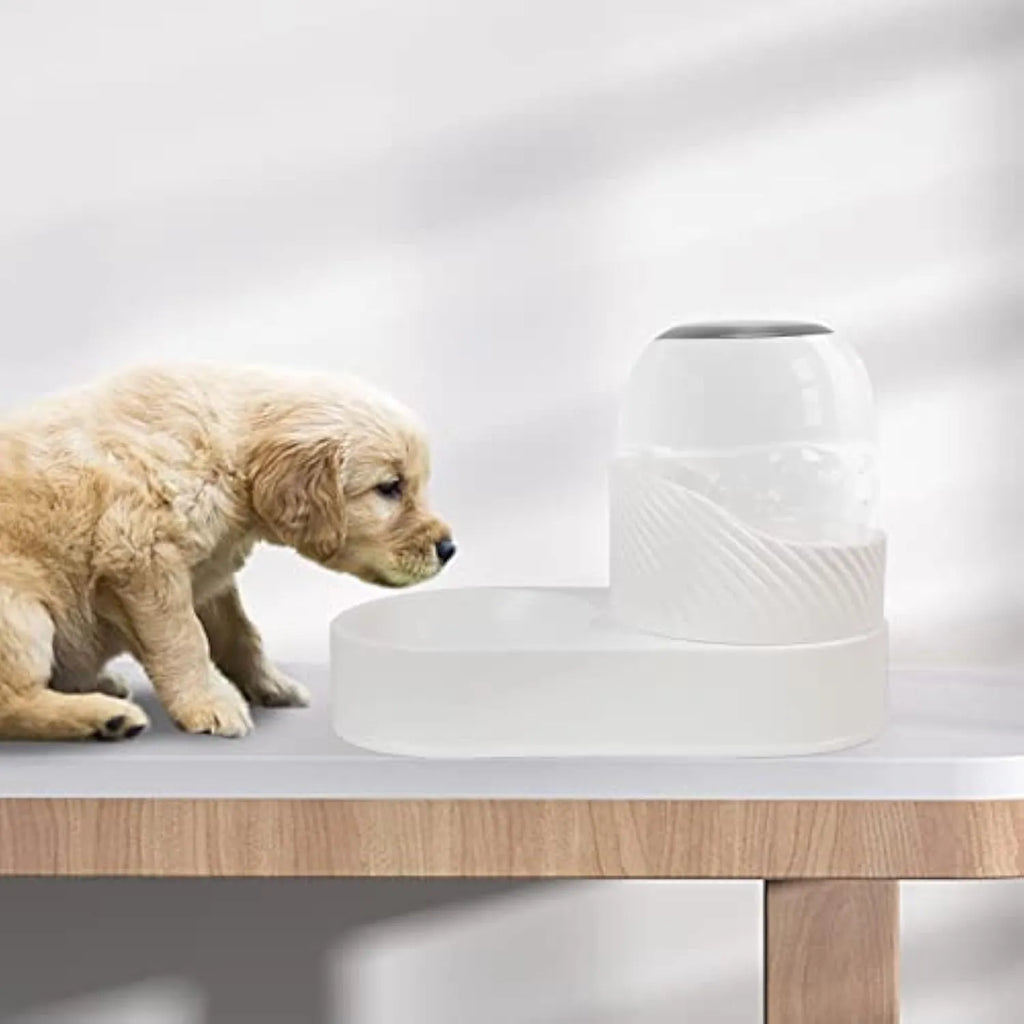 White automatic cat feeder and water dispenser set with wave-shaped design on a table.