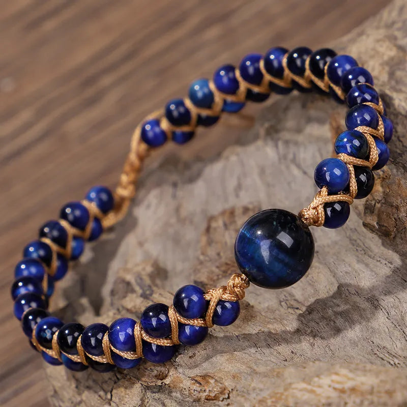Handwoven geometric pull bracelet with blue tiger eye stone beads.