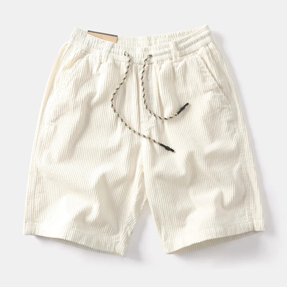 Men's khaki retro cargo shorts with a straight leg on a summer streetwear backdrop.