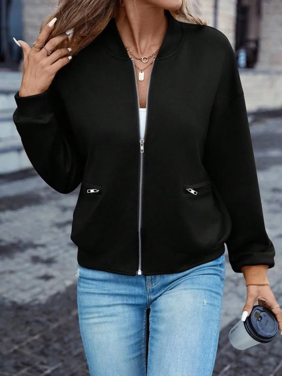 Black women's casual zip jacket with long sleeves on a hanger