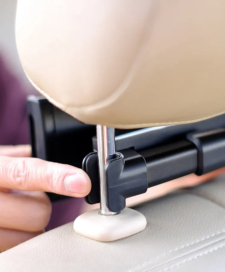 Black car phone holder attached to vehicle rear seat base with universal bracket holding tablet