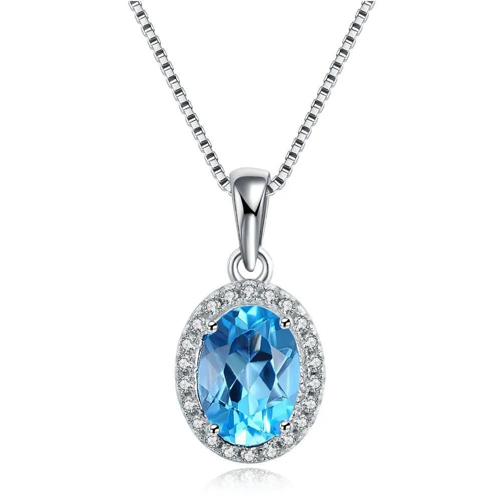 925 sterling silver geometric jewellery set with blue topaz gemstones, showing earrings, ring, pendant, and necklace.