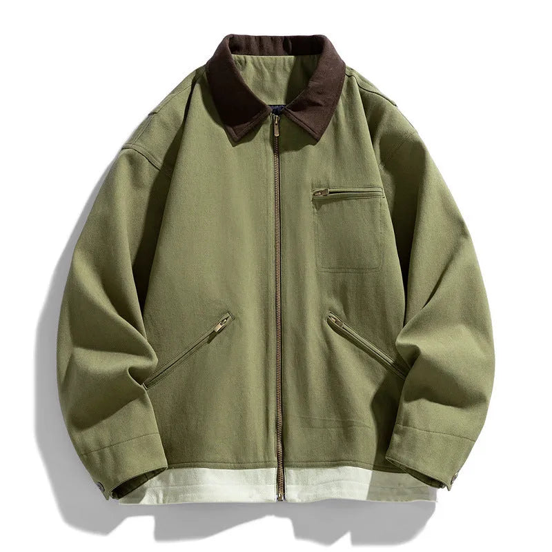 Man wearing a loose-fit mint green retro workwear jacket with contrast lapels and side pockets.