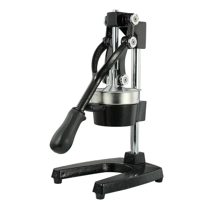 Black and white manual cast iron citrus juicer with stainless steel funnel on kitchen counter