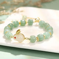 Rabbit charm bracelet with natural stone beads on copper-plated chain with gold accents