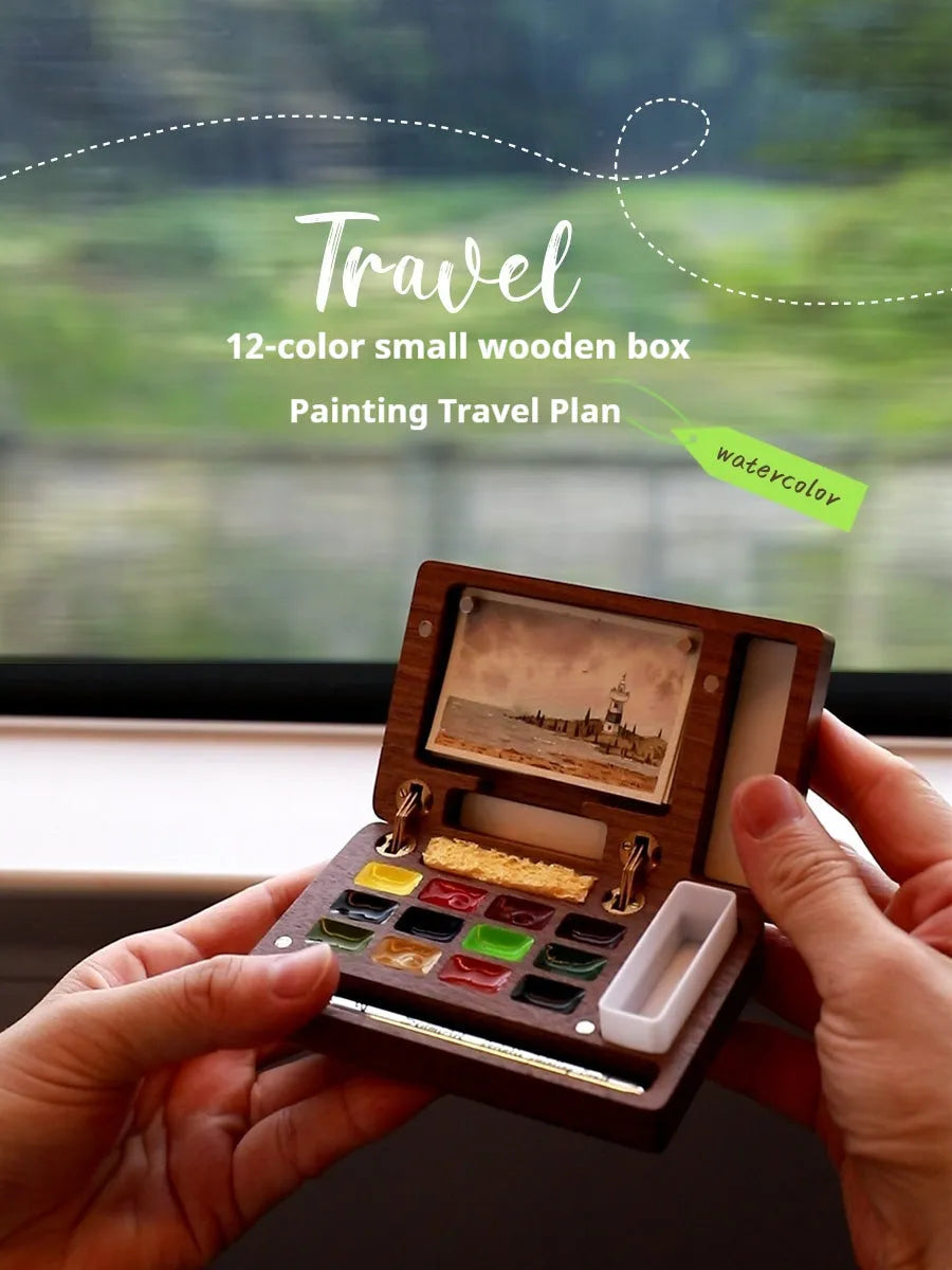 Mini solid walnut wood watercolour paint box with open lid showing internal compartments for half-pan pigments.