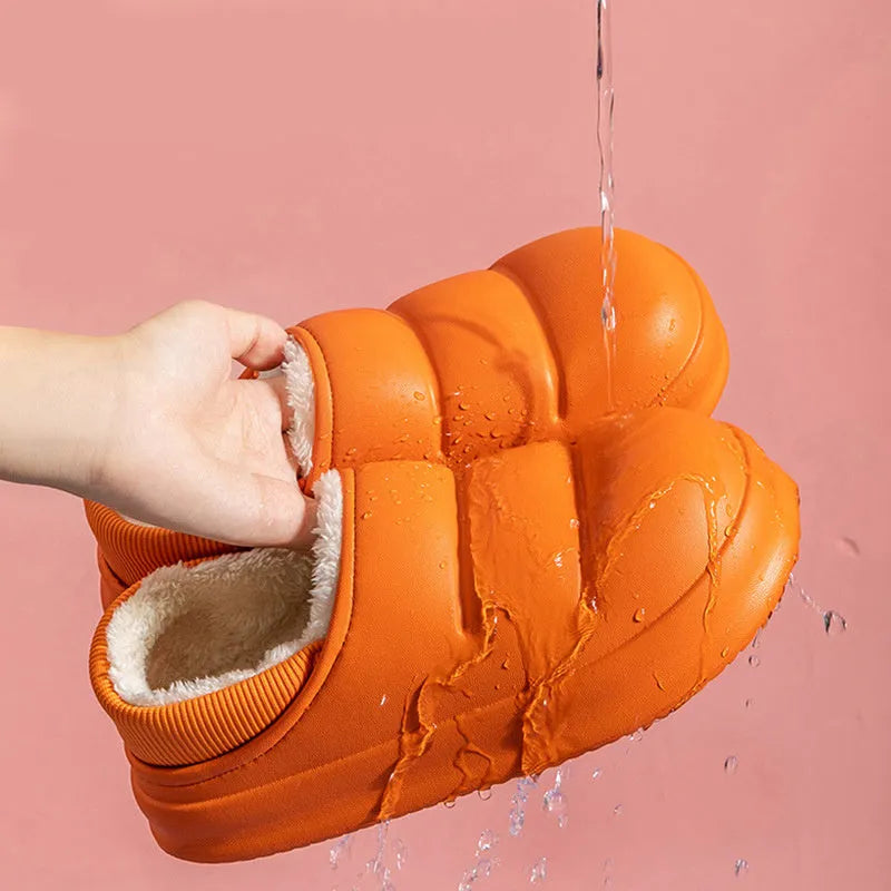 A pair of waterproof EVA couple slippers with a warm plush lining, shown in a green colour option.