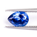 Royal blue love shaped tiara gemstone in heart and round cuts on a grey background.