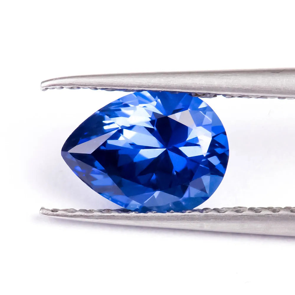 Royal blue love shaped tiara gemstone in heart and round cuts on a grey background.