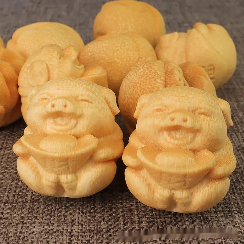 Small solid bamboo carving ornament in the shape of a cute pig ingot, 4cm height, natural wood colour