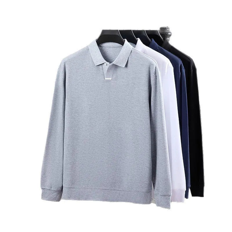 Man wearing a loose-fit grey cotton polo shirt with an asymmetric lapel, long sleeves, and a casual style.