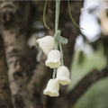 Green and white knitted wool car plant decoration with plastic base and hanging rope