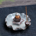 Ceramic reverse flow incense burner with purple clay construction and traditional good luck decorative motifs