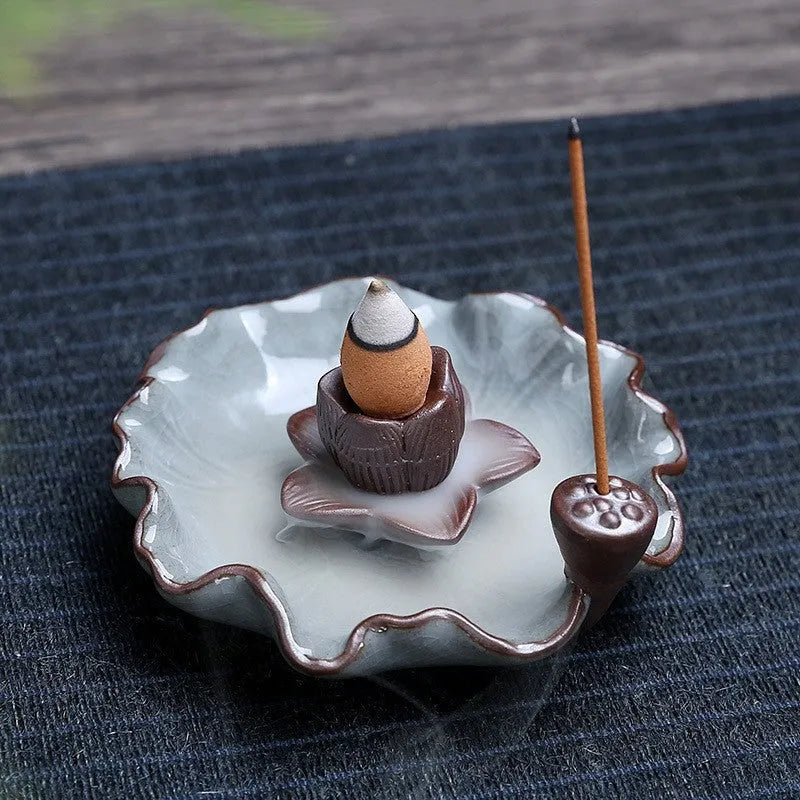 Ceramic reverse flow incense burner with purple clay construction and traditional good luck decorative motifs