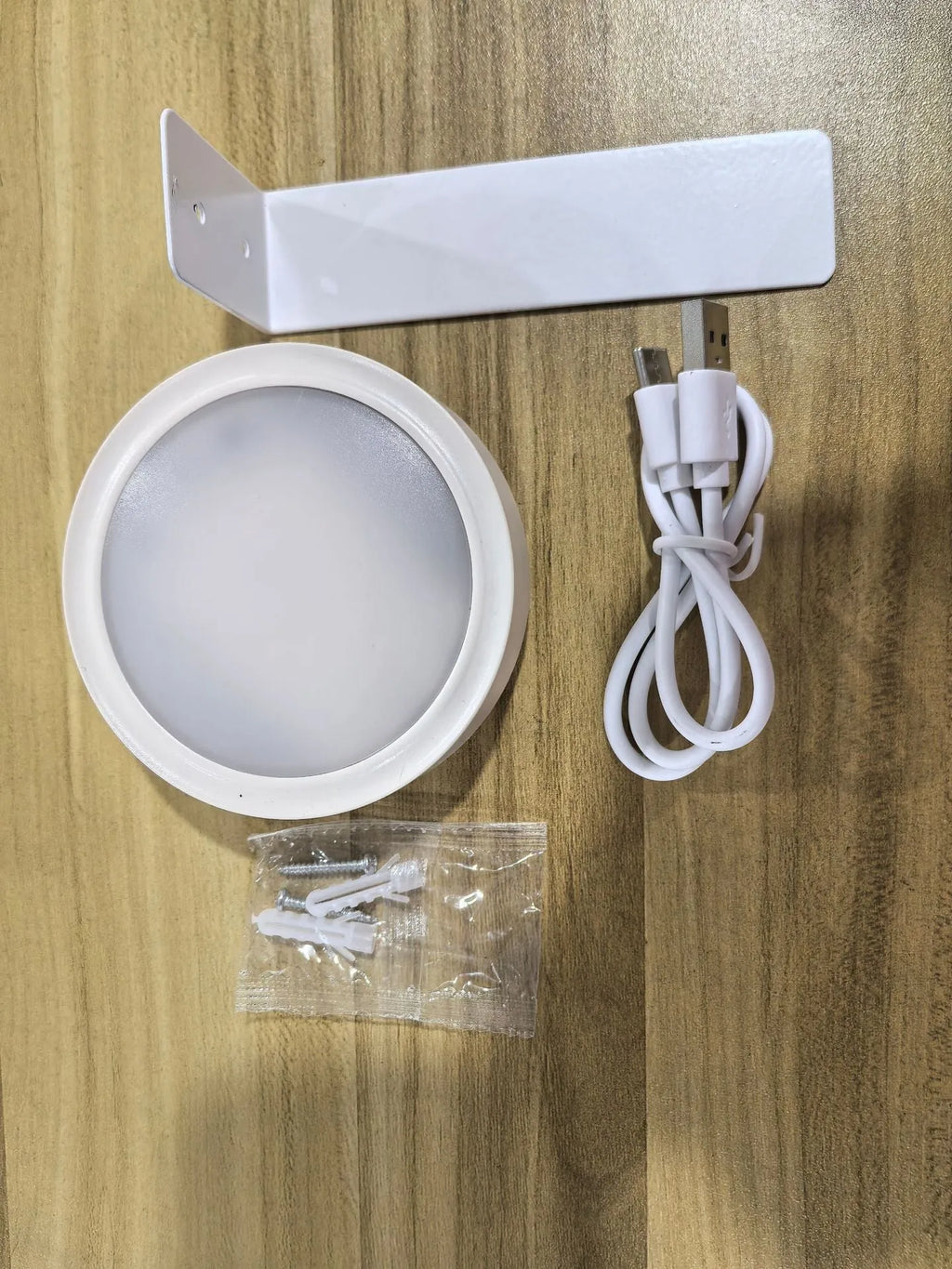 Black remote control LED magnetic picture light mounted above a painting, showing wireless power supply.