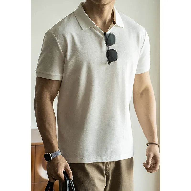 Man wearing a classic blue short-sleeved cotton blend polo shirt, showing regular fit and button placket.