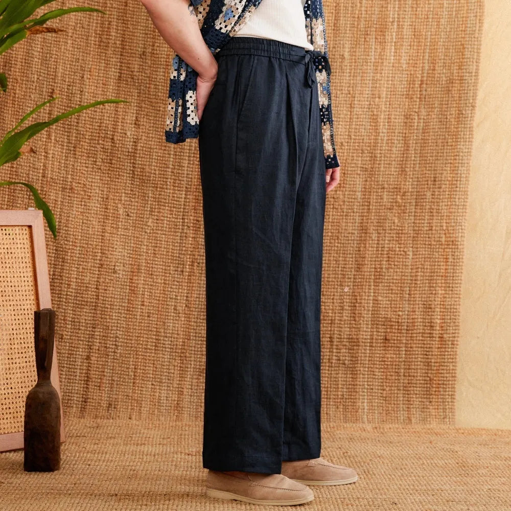 Women's loose fit high waist linen trousers in greige colour with straight leg and elasticated waistband.