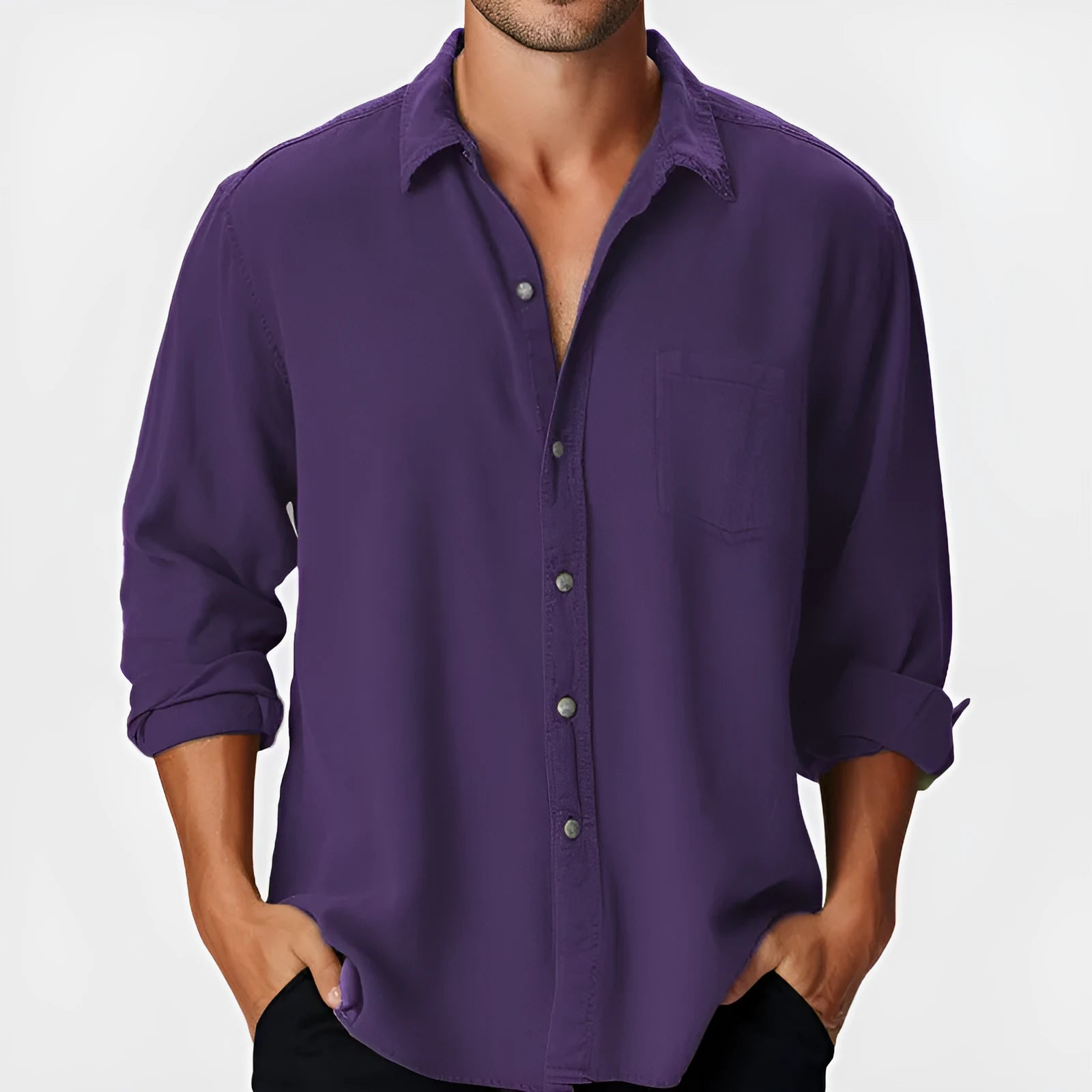 Man wearing a solid-colour loose-fit long sleeve casual shirt with a stand collar.