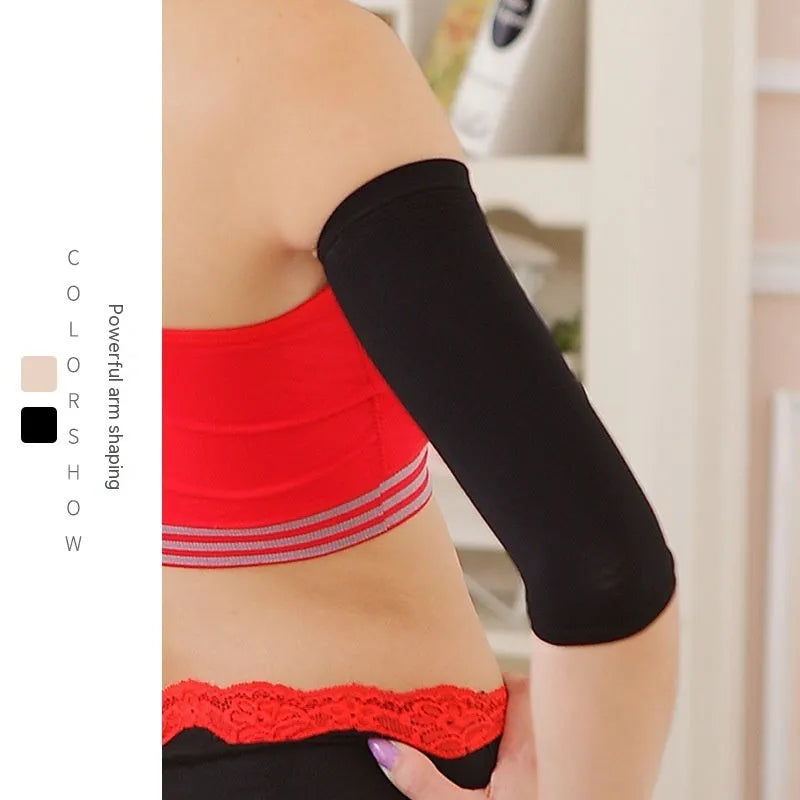 A pair of solid-colour women's shaping arm sleeves in nylon, shown in black and skin tone on a mannequin arm.