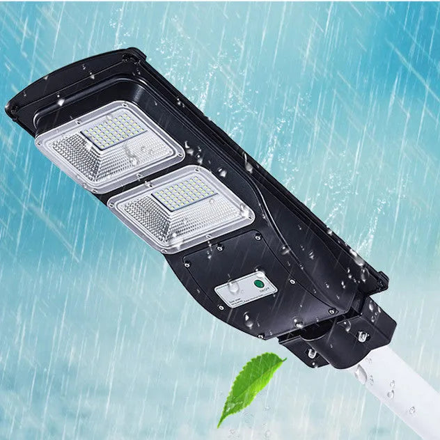 Integrated solar street light with solar panel and LED light in single housing unit for outdoor installation