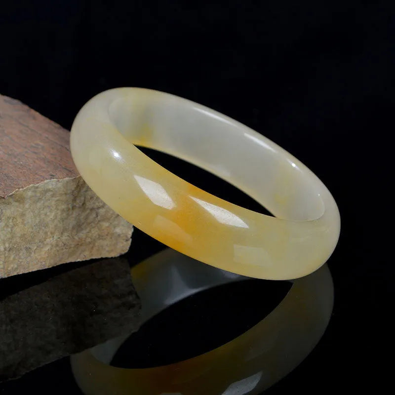 Natural light jade bracelet for women showing polished Chinese style design on wrist