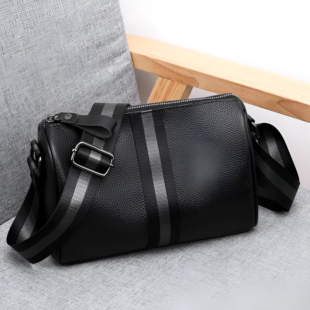 Black genuine leather one-shoulder crossbody bag showing front view and spacious interior.