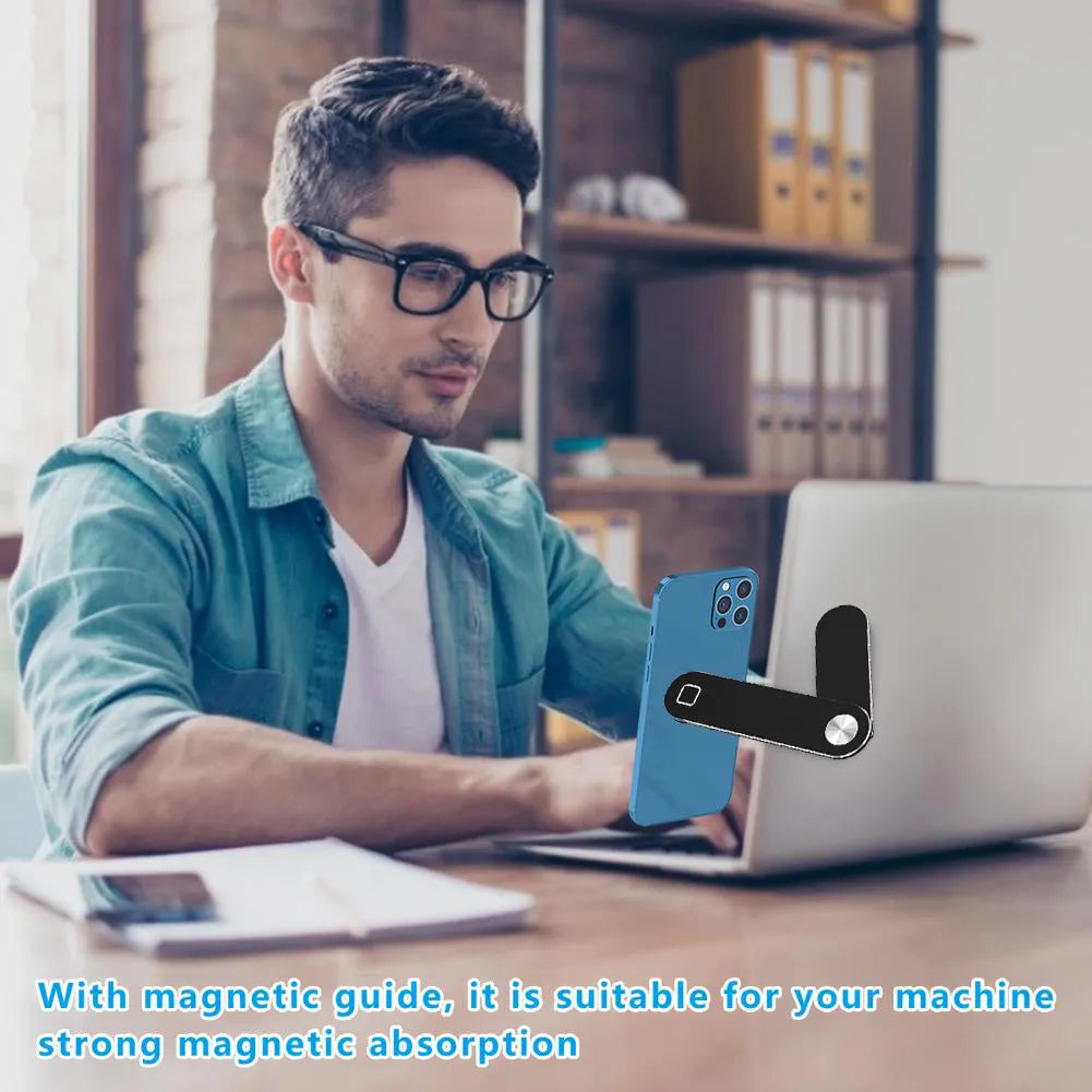 Black aluminium magnetic phone holder clipped to the side of a silver laptop.
