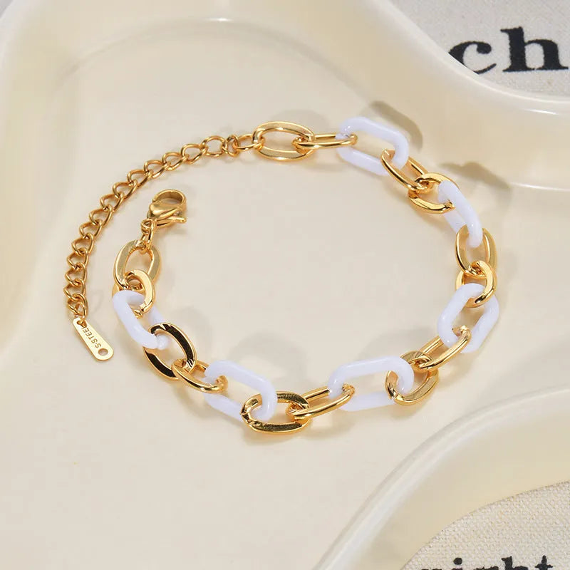 Women's stainless steel bracelet with a double-layer resin heart pendant.