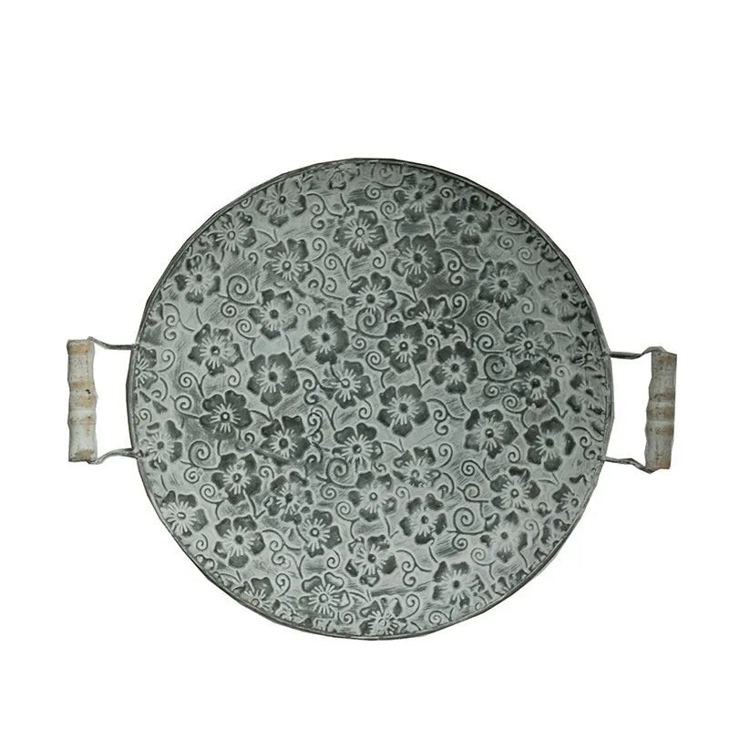 Round European wrought iron belt storage tray in two size options on a wooden surface.