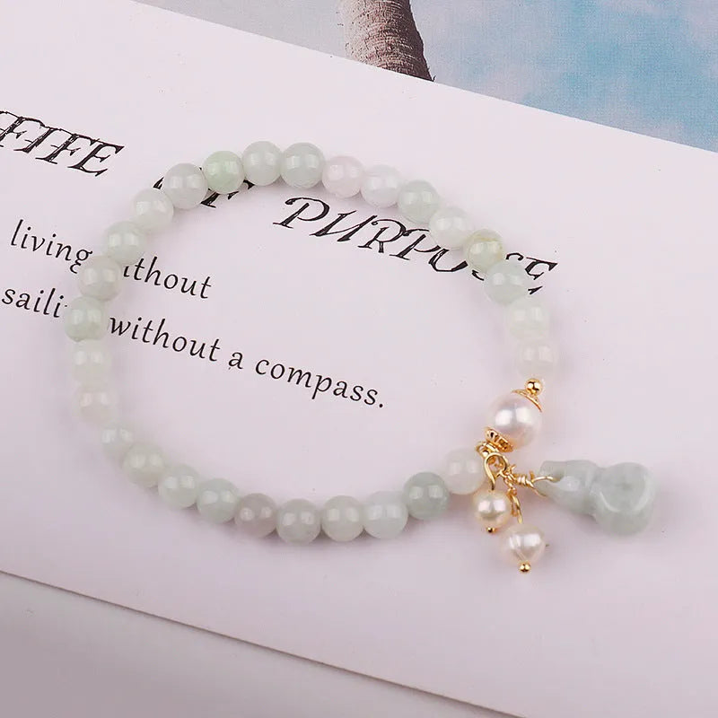 Natural jade bracelet with hand-carved gourd design in Chinese women's style.