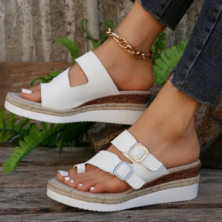 White patent leather wedge sandals with peep toe woven design and finger fit construction
