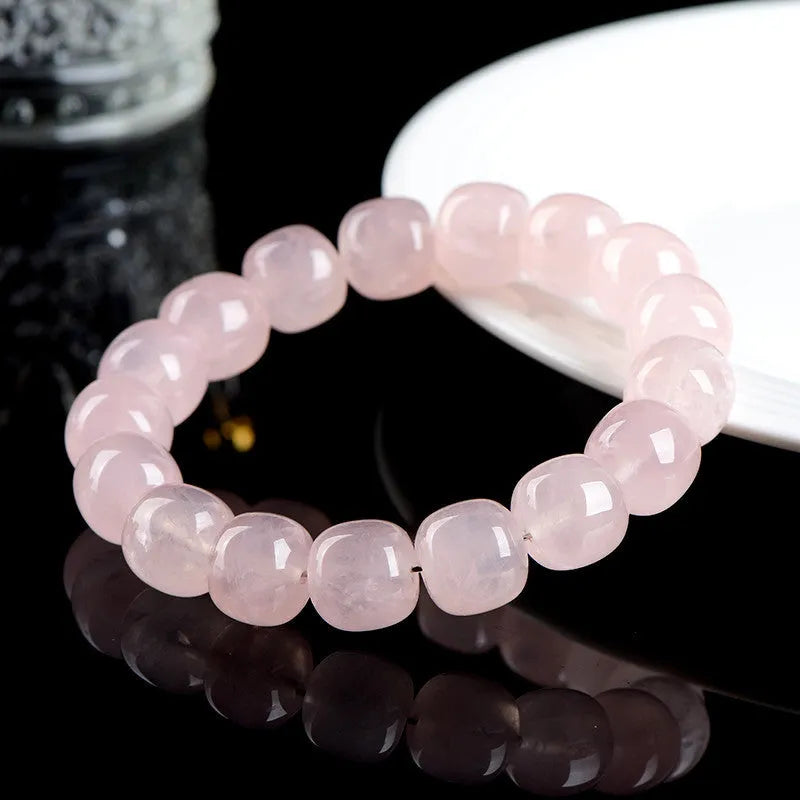 Pink crystal geometric barrel bead bracelet with 11-12mm beads on a wrist.