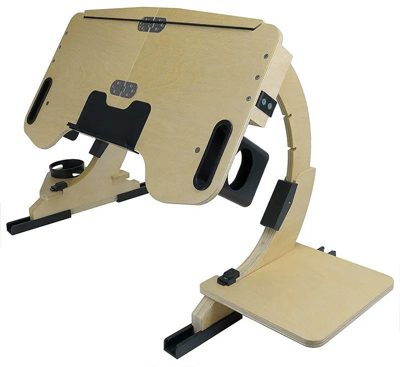 Wooden folding laptop table with adjustable angle on a bed, in black finish.