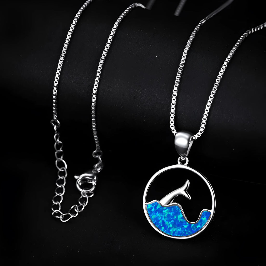 White gold colour electroplated necklace with a round sea fishtail pendant featuring a blue opal stone.