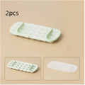Yellow high-capacity plastic ice cube tray with leverage design and integrated shovel storage slot