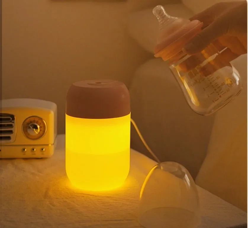 Small white cylindrical USB-powered humidifier on a desk