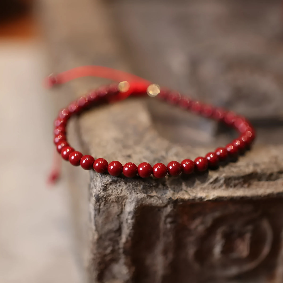 Close-up of a purple gold sand design cinnabar bracelet with geometric Chinese patterns.