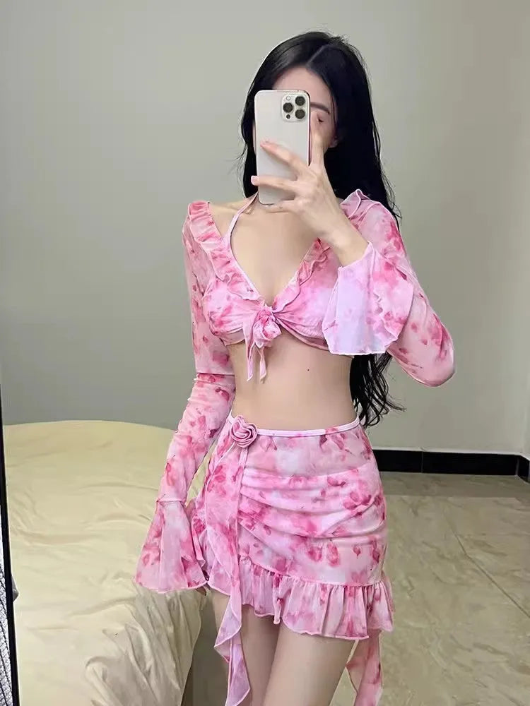 Women's cherry blossom pink floral print bikini swimsuit set on a white background.