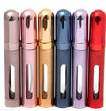 12ml aluminium portable perfume bottle in bullet shape with glass liner, shown in various colours.