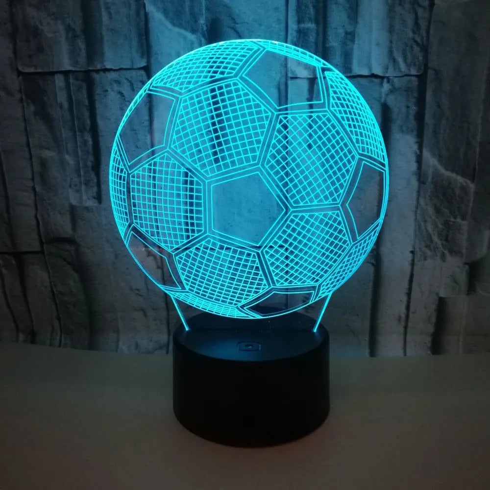 3D football-shaped acrylic night light displaying blue LED colour on a black ABS base.