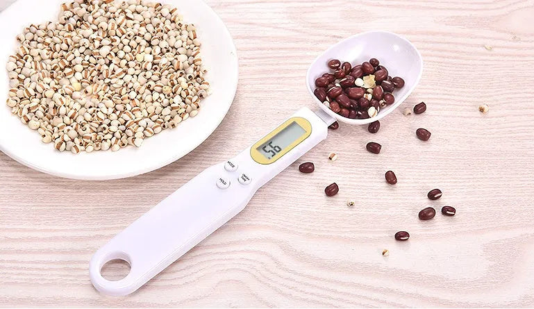 Black electronic measuring spoon scale showing digital display and integrated spoon design for kitchen weighing