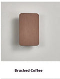 Minimalist modern wall lamp with a slim metal frame in a choice of four finishes, mounted on a wall.