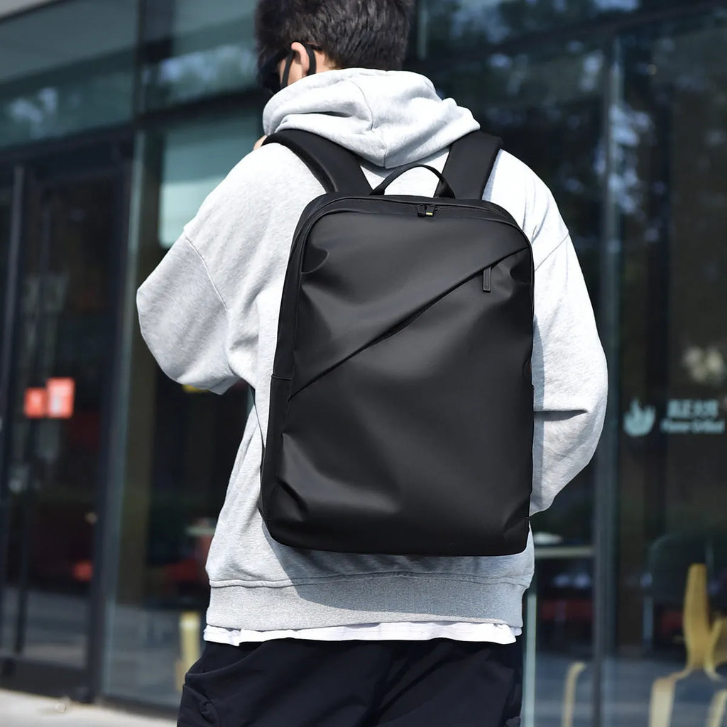 Large waterproof PU leather backpack for men with visible stitching details in black colour