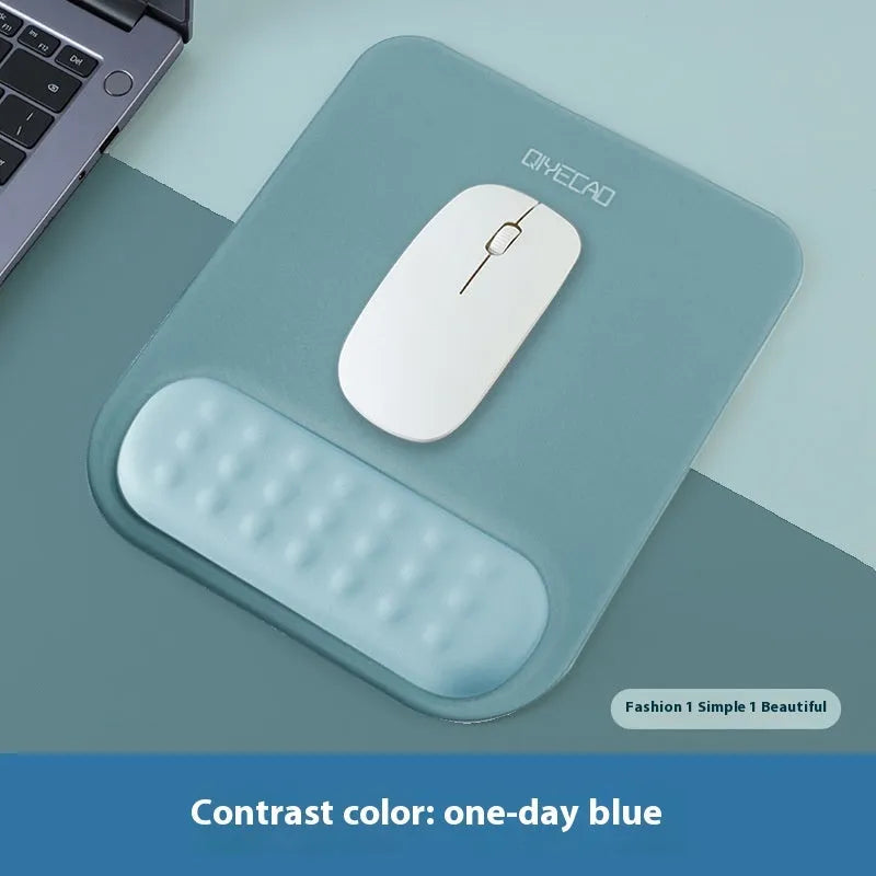 Ergonomic cloth-silicone mouse pad with raised wrist support on a desk