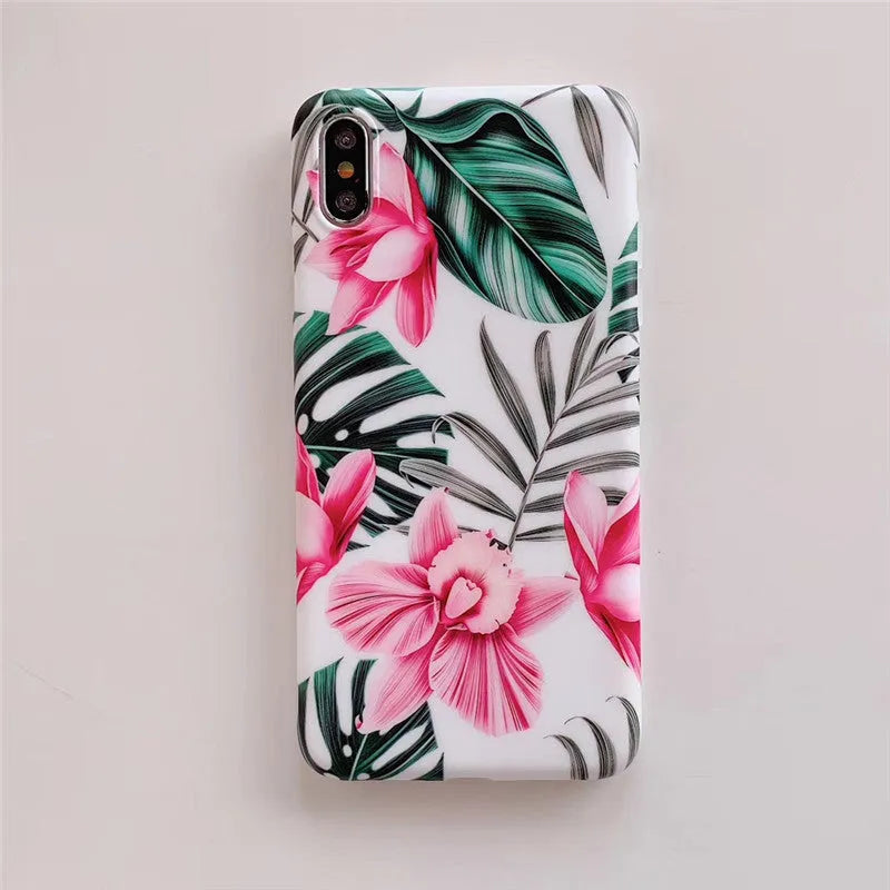 Pink floral pattern TPU back cover case for iPhone on a table.