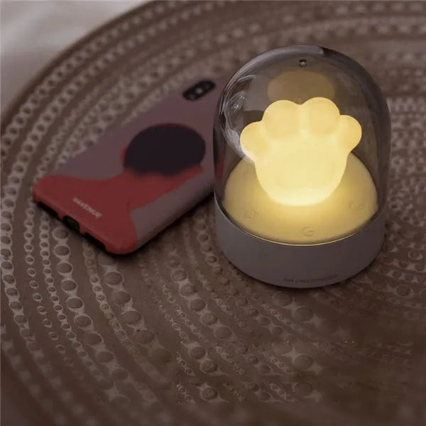 Grey cat paw shaped night light with USB charging cable and adjustable brightness controls